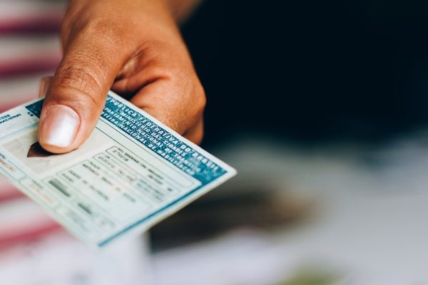 Man holds National Driver's License (CNH). Official document of Brazil, which attests the ability of a citizen to drive land vehicles.